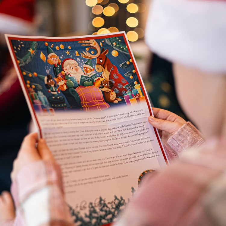 Child holding a personalised Santa letter